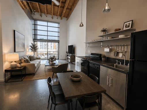 A modern kitchen with a dining table and chairs.
