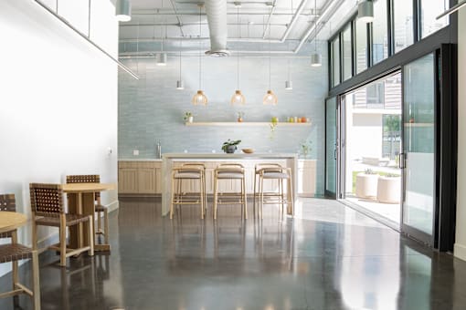 A modern dining area with wooden chairs and tables.