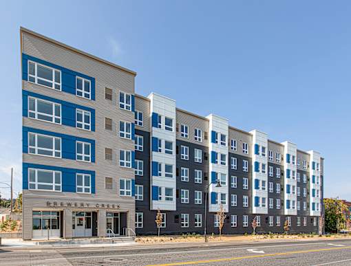 A multi-story building with the name Brewery Creek on the front.