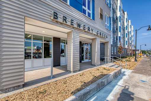 A building with a sign that says Brewery Green.