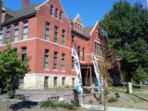 A red brick building with a banner that says "SCHOOL" on it.