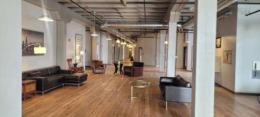 A spacious office lobby with a variety of seating options and a modern design.