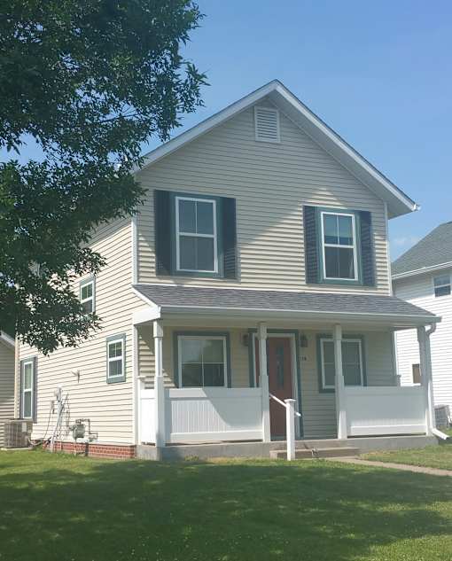 A house with a red door and white porch.