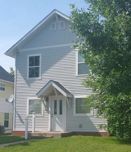 A house with a white door and windows.
