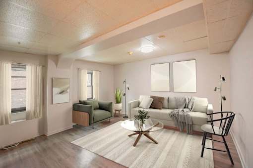 A living room with a white couch, a green armchair, and a wooden coffee table.