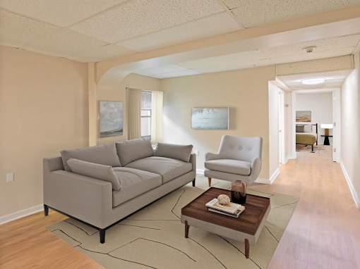 A living room with a grey couch, a white chair, and a coffee table.