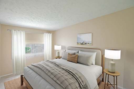 A bedroom with a bed, two lamps, and a painting on the wall.