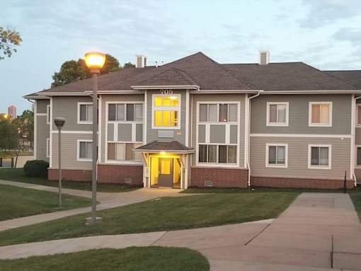 A building with a yellow light on the front door.