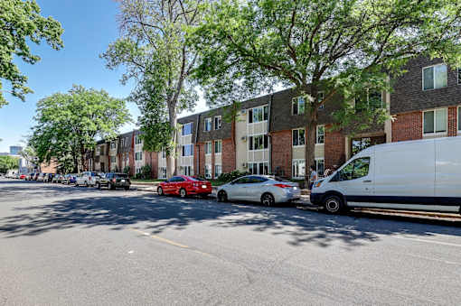 A red car is parked on the side of the street.