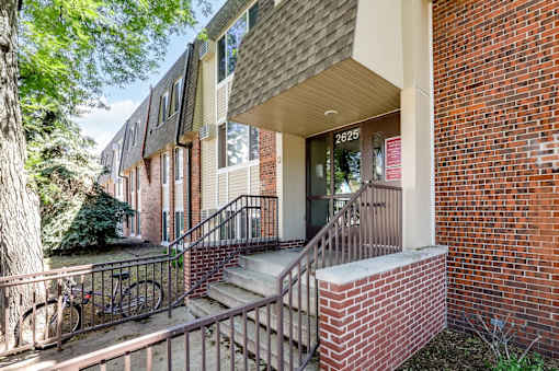 A brick building with the number 2625 on the front door.