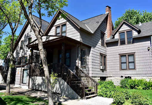 A house with a grey exterior and a brown roof.