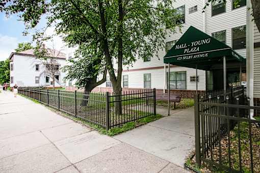A green canopy with white lettering reads "Hall-Young Plaza.".