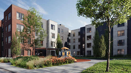 A modern apartment complex with a playground in the foreground.