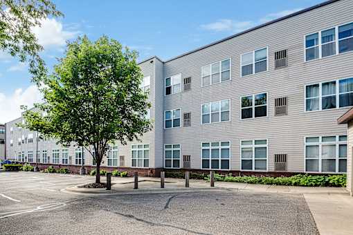 A large building with a parking lot in front of it.