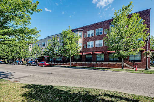 A red car is parked on the side of the street.