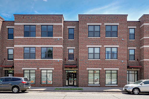 A red brick building with a clear blue sky in the background.
