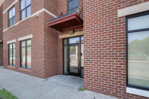 A red brick building with a black door and windows.
