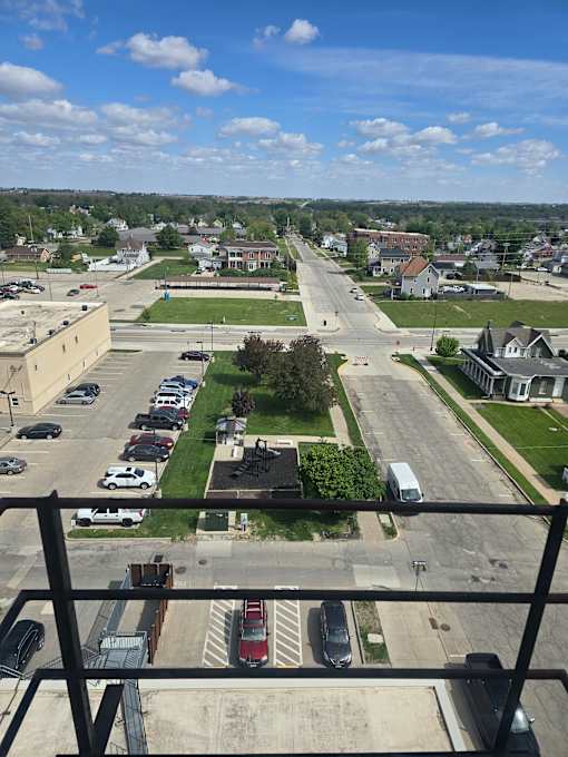 A view from a high vantage point looking down at a parking lot and street.