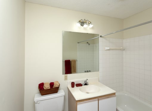A white toilet sits next to a sink in a small bathroom.