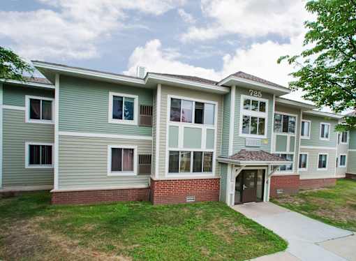 Apartment building number 725 with a green lawn in front.