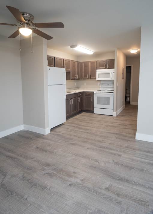 A kitchen with a white fridge and a white oven.