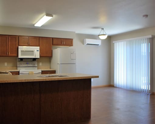A kitchen with wooden cabinets and a white refrigerator.