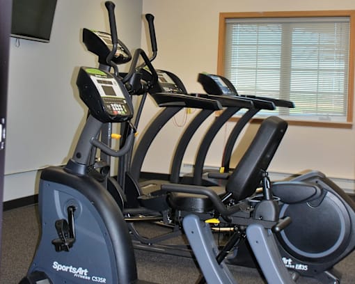 A SportsArt exercise bike is in a room with a window.