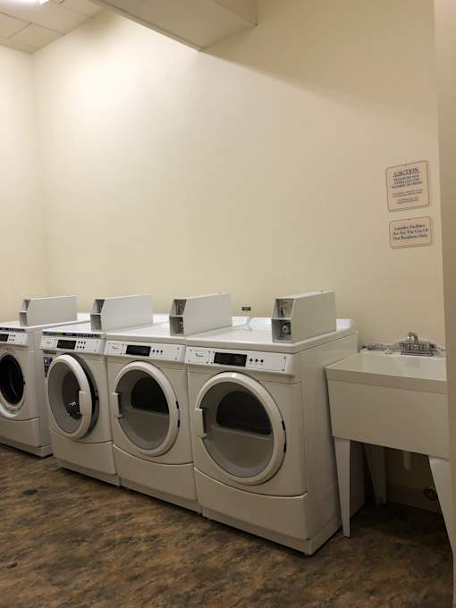 A row of washing machines in a laundromat.