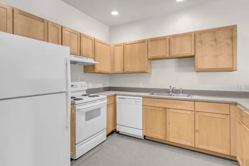 A kitchen with wooden cabinets and white appliances.