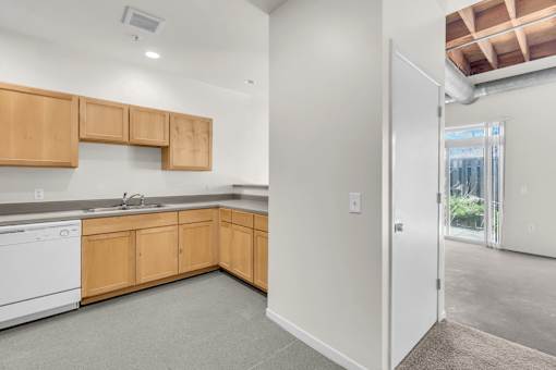 A kitchen with wooden cabinets and a white dishwasher.