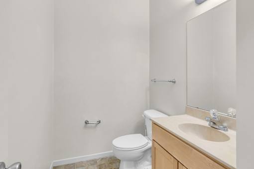 A white toilet sits next to a sink in a bathroom.