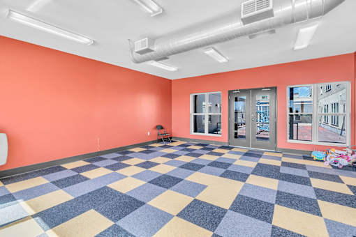 A room with orange walls and a checkered floor.