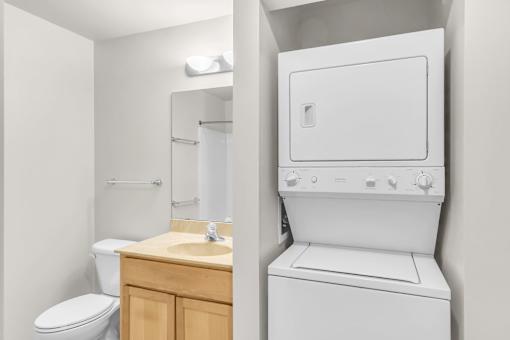 A white washing machine in a small bathroom.