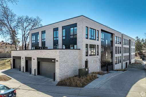 A modern building with a mix of white and black exterior.