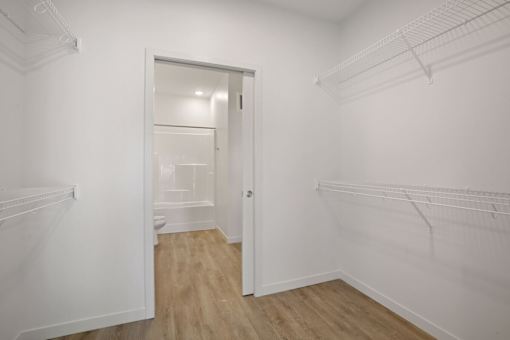 A white room with a doorway leading to another room.