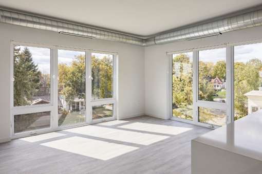 A room with white walls and a white table with a white box on it.
