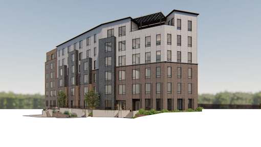 A modern multi-story apartment building with a mix of dark and light brown balconies.