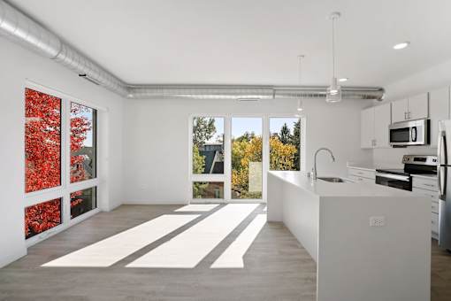 A kitchen with white cabinets and a white counter top.