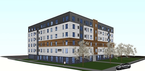 A modern multi-story apartment building with a car parked in front.