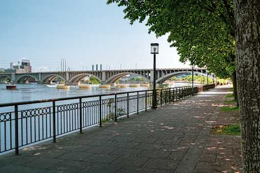 A bridge over a river with a walkway on the side.