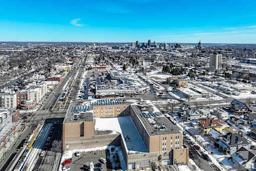A cityscape with buildings and roads covered in snow.