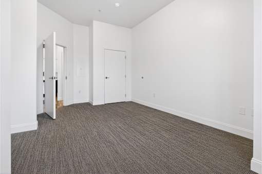 A room with a carpeted floor and white walls.