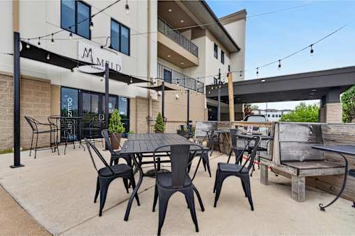 A patio area with tables and chairs is shown.