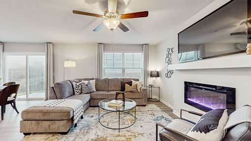 A modern living room with a fireplace and a flat screen TV.
