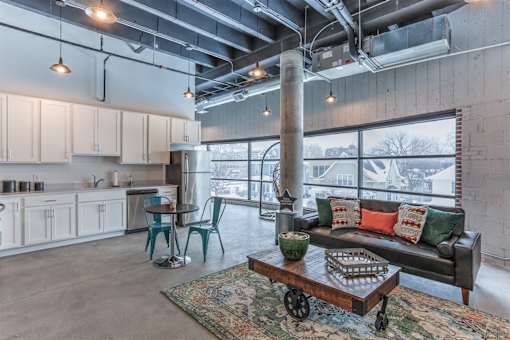 A living room with a couch, chairs, and a coffee table.