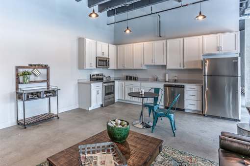 A modern kitchen with a dining table and chairs.