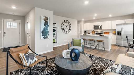 A modern living room with a large coffee table and a bar area.