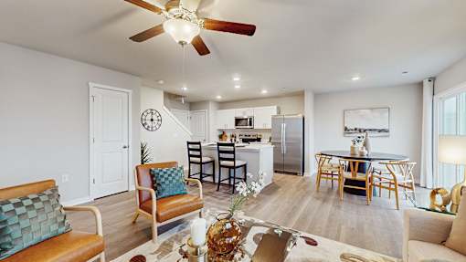 A living room with a dining table and chairs.
