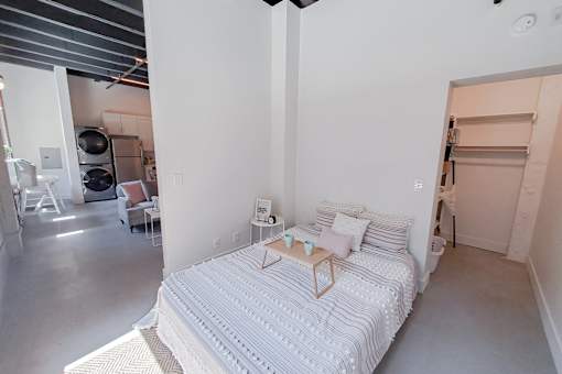 A bedroom with a large bed and a striped headboard.