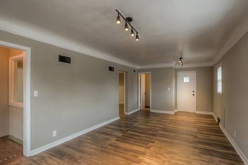 A room with wooden floors and white walls.